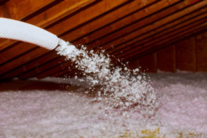 Roof technician spraying foam insulation 